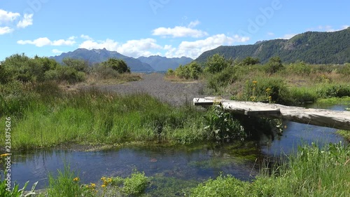 Wooden bridge over the creek near Tromen Lake. Lanin NP, Patagonia, Neuquen, Argentina photo