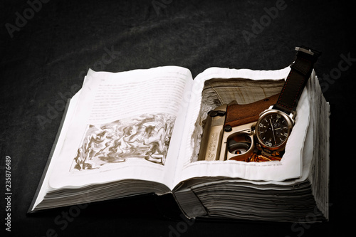 Wristwatch and gun in book safe