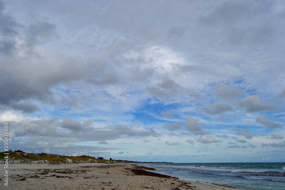Landscape of a beach at sunset with clouds and ocean in the horizon Landscape of a beach at sunset with clouds and ocean in the horizon