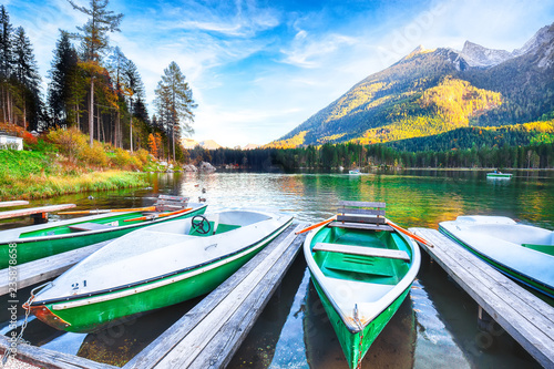 Fantastic autumn evening at Hintersee lake. Few boats on the lake