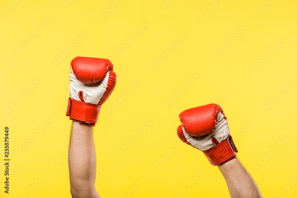 cropped shot of person in boxing gloves isolated on yellow