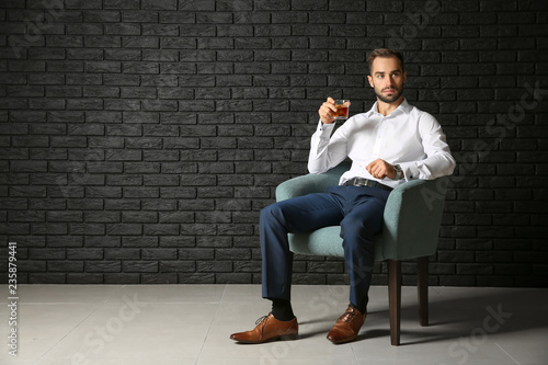 Young businessman drinking ...