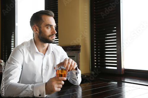 Young man drinking whiskey ...