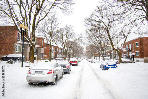Montreal residential street during a snowfall in early winter © Guy