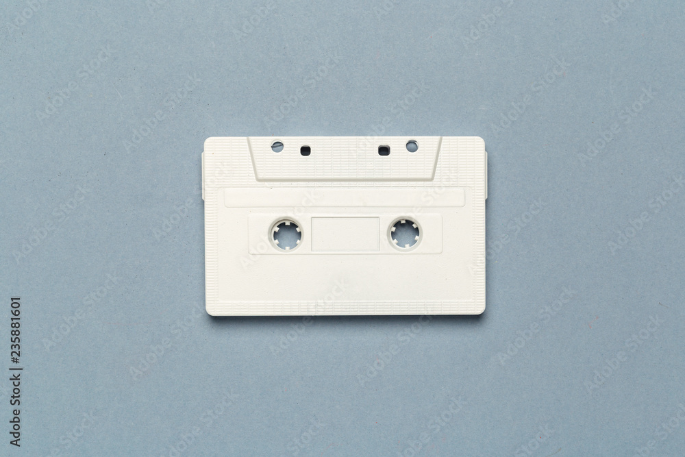 One single retro audio cassette on light grey background, top view One single retro audio cassette on light grey background, top view