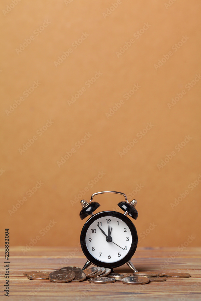 Time is money, table clock with coins Time is money, table clock with coins