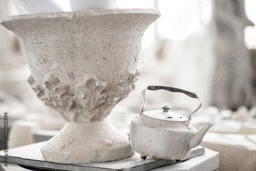 Old vase with teapot in the sculptor's studio photo