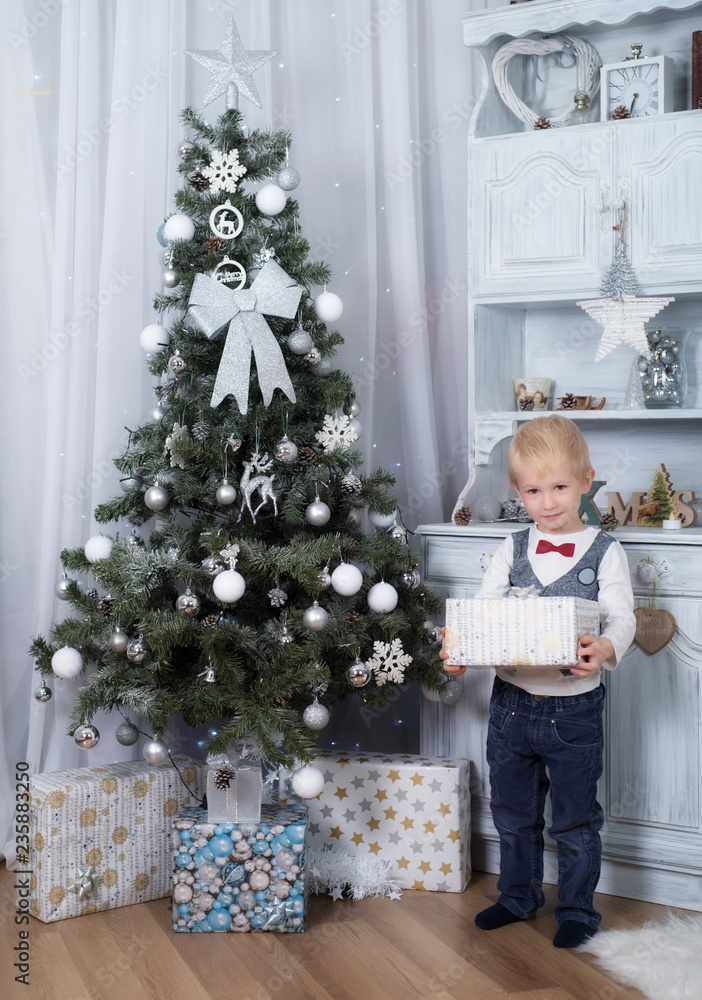 Adorable child holding a gift box Adorable child holding a gift box