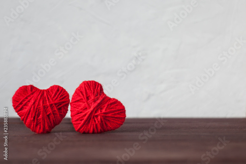 two red hearts from wool thread. Valentine s day concept.