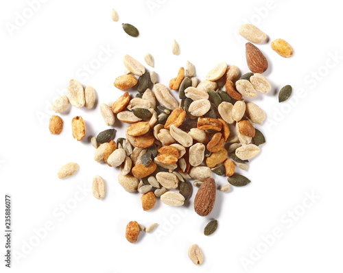 Healthy food mix of salted and spicy peanuts, sunflower and pumpkin seeds, almonds isolated on white background, top view