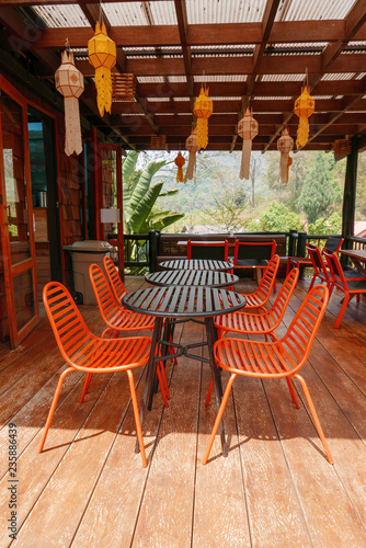 Orange outdoor table & chairs in bistro café in daytime for relaxation, travel, season, time, holiday, gastronomy, concept