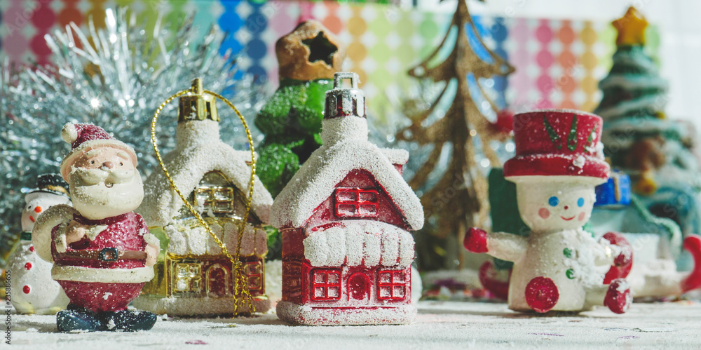 Santa Claus, snowman, houses & snow Sledge miniature model studio shot on colorful background for family, giving, season, Christmas, holiday, new year, travel and gathering concept