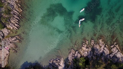 Aerial drone footage of people paddling in paradise by the shore in Split, Croatia. photo