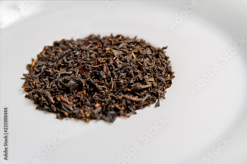 Black tea leaves on a white background