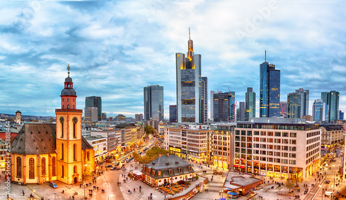 Frankfurt, Germany - November, 2018: View to skyline of Frankfurt during sunset. St. Catherine's Church and the Hauptwache Main Guard building with famous Frankfurt skyscrapers. photo
