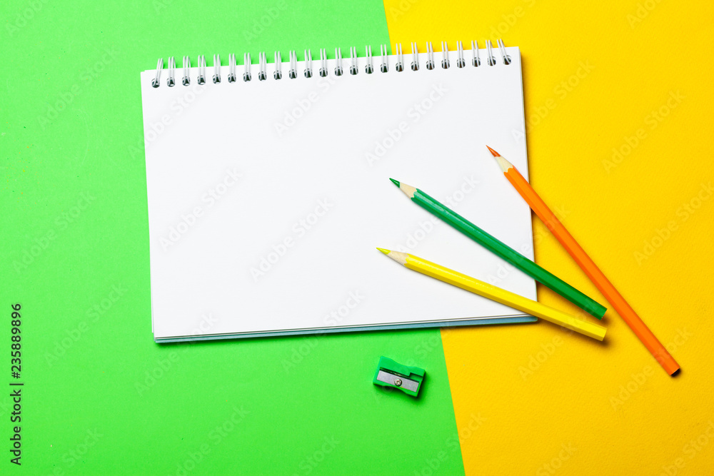 Blank notepad and pencil color on a table blackground Blank notepad and pencil color on a table blackground