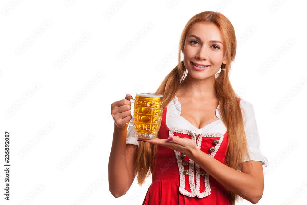 Young beautiful sexy Bavarian woman wearing dirndl smiling to the camera, posing gracefully with beer in her hand isolated. Attractive waitress offering glass of beer, celebrating St. Patrick Young beautiful sexy Bavarian woman wearing dirndl smiling to the camera, posing gracefully with beer in her hand isolated. Attractive waitress offering glass of beer, celebrating St. Patrick