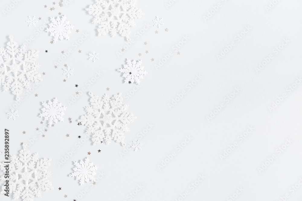 Christmas composition. Christmas frame made of white snowflakes on pastel gray background. Winter concept. Flat lay, top view, copy space Christmas composition. Christmas frame made of white snowflakes on pastel gray background. Winter concept. Flat lay, top view, copy space