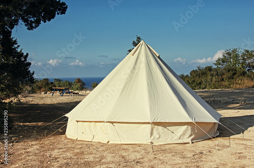 Glamping campsite near the sea. Big camping tent for luxury outdoor vacation