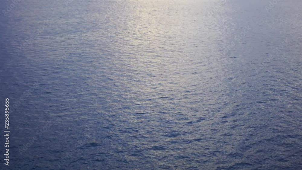 Blue sea water with soft reflection of sunset sun on calm surface. Nature background. Real time 4k video footage. Blue sea water with soft reflection of sunset sun on calm surface. Nature background. Real time 4k video footage.