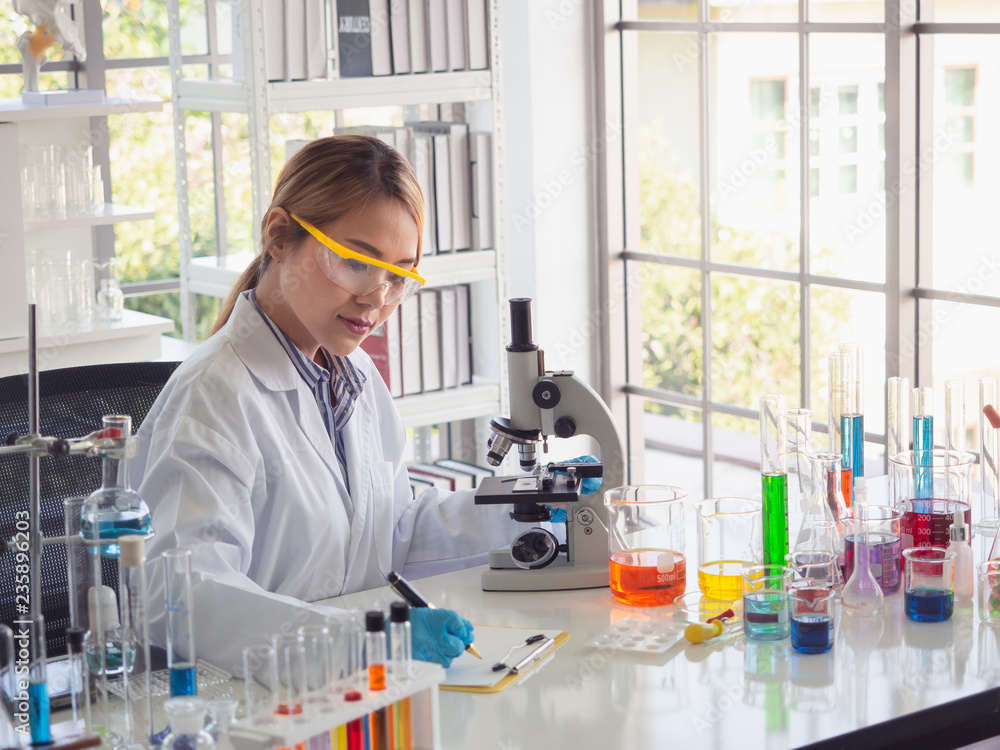asian scientist working in laboratory with microscope asian scientist working in laboratory with microscope