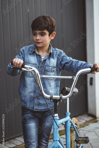 Portrait of a boy on a bicycle in park outdoors