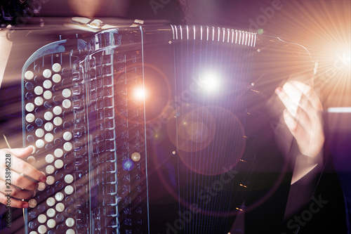 Photos Close-up musician playing the accordion on the stage