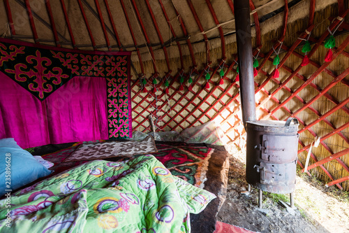 Interior shot of a traditional yurt with stove at Song Kul lake in Kyrgyzstan