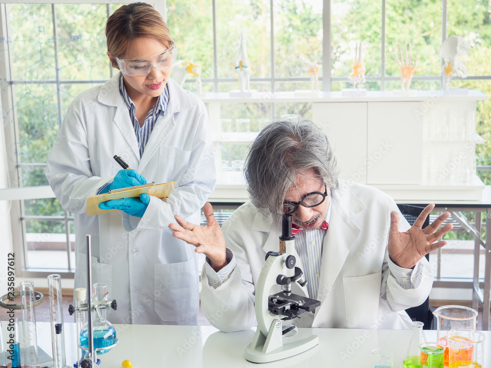 asian scientist working in laboratory with microscope asian scientist working in laboratory with microscope