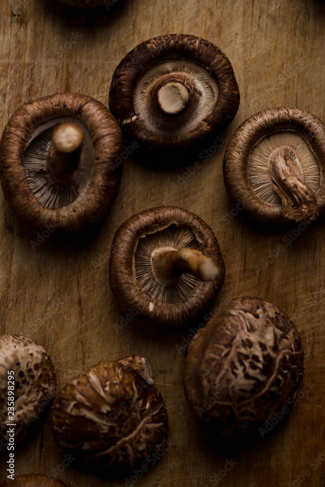 Shiitake mushrooms on old wooden table Shiitake mushrooms on old wooden table