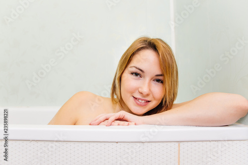young woman is relaxing in a bathtube