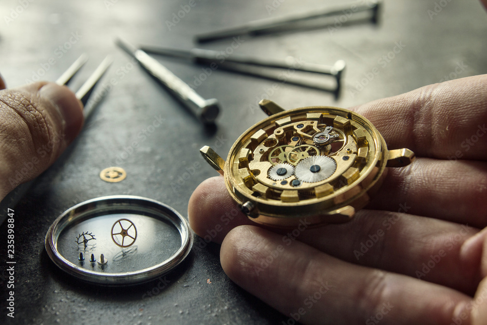 Watchmaker is repairing the mechanical watches in his workshop Watchmaker is repairing the mechanical watches in his workshop