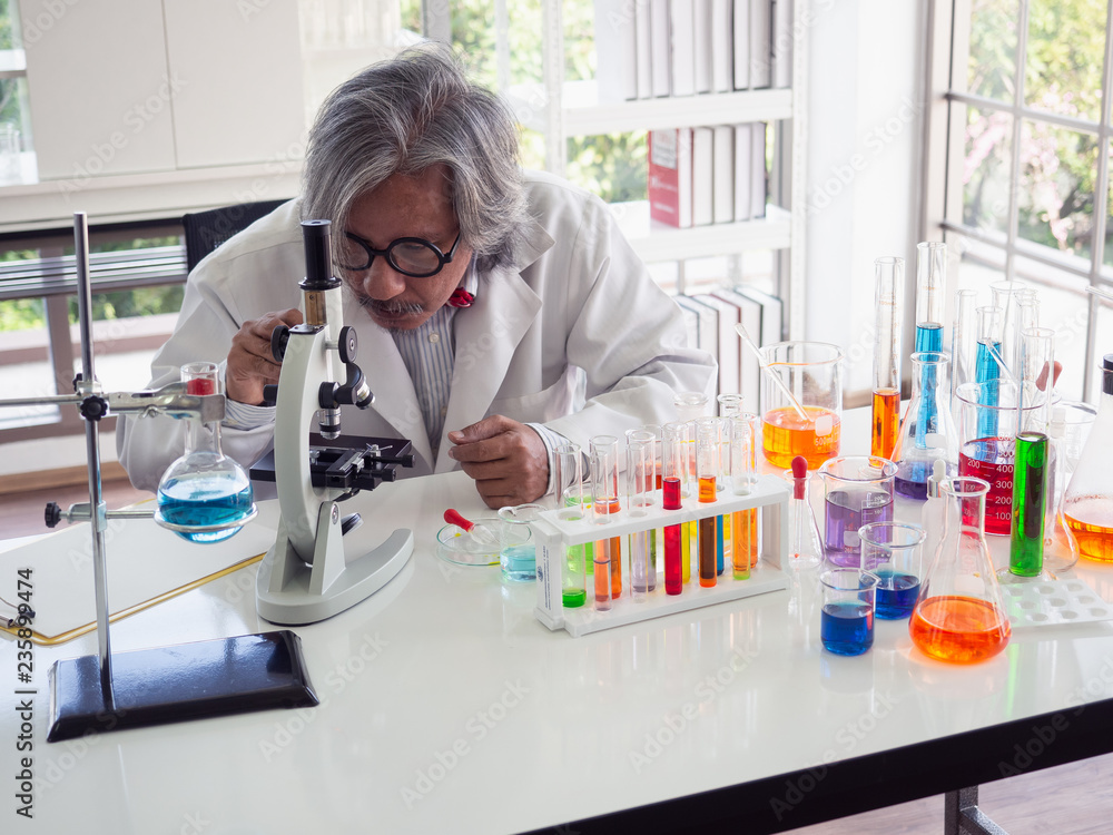 asian scientist working in laboratory with microscope