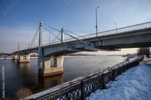 the automobile bridge through the Volga River against the background of the blue sky