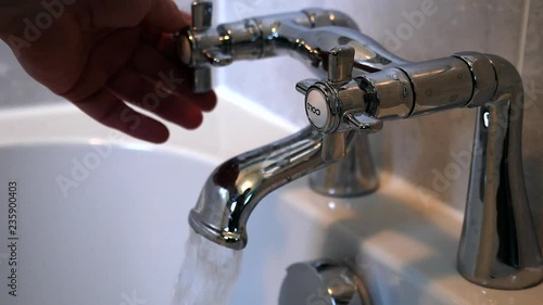 Turning on a tap and running a bath
