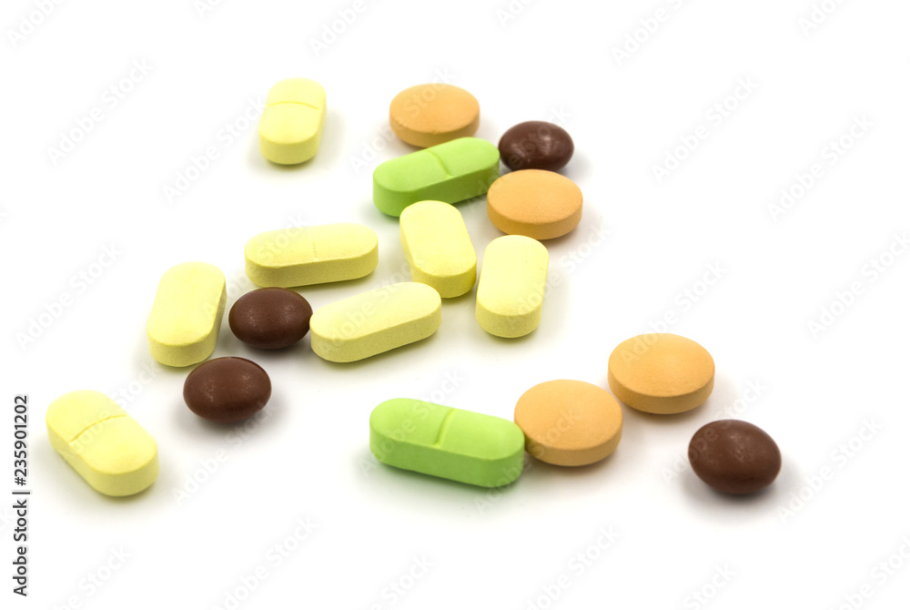 Multicolored tablets and pills on a white background Multicolored tablets and pills on a white background