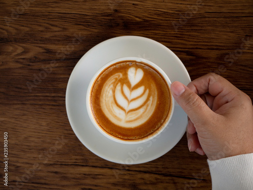 coffee latte with beautiful latte art on hand