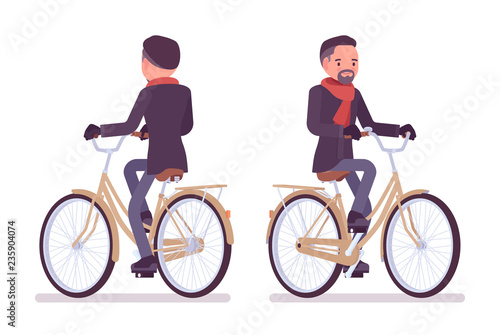 Stylish middle aged man in autumn wear riding city bike