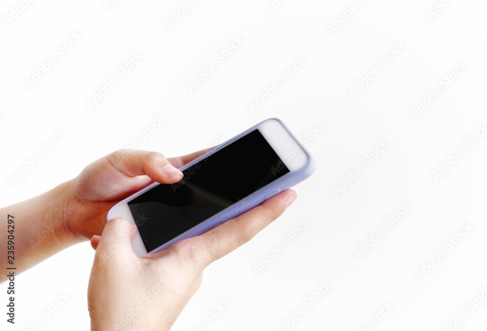Close up young female hands is using mobile phone on isolated white background Close up young female hands is using mobile phone on isolated white background