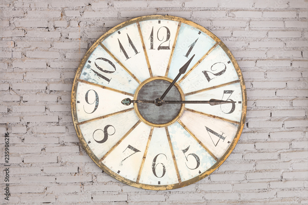 Retro clock showing one fifteen on the wall Retro clock showing one fifteen on the wall