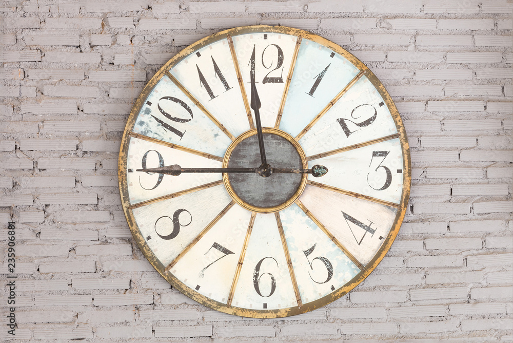 Retro clock showing eleven forty five on the wall