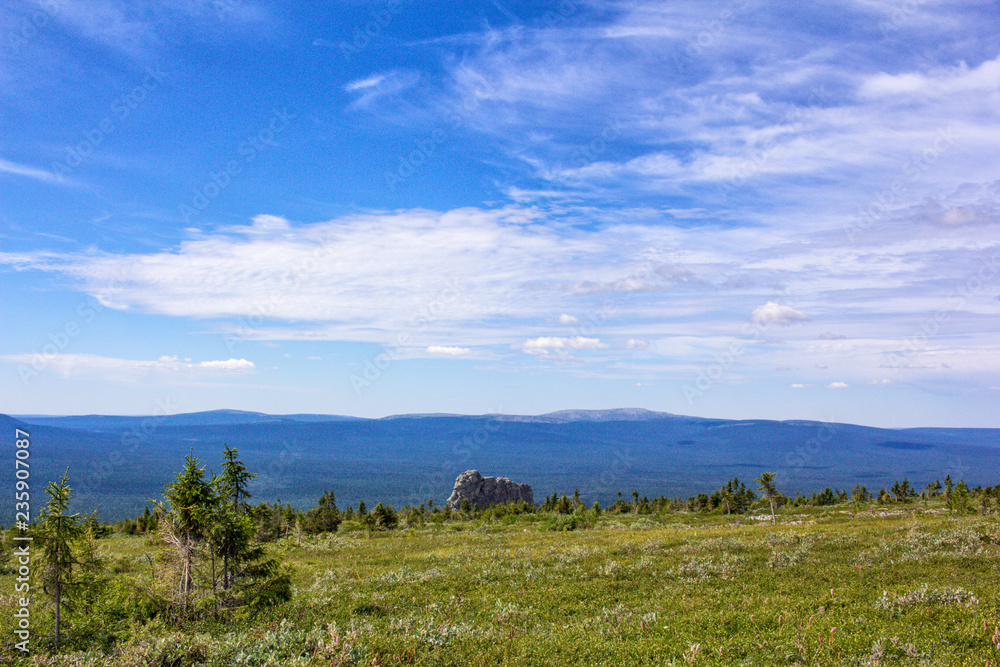 Magnificent view of the mountain tops from the plain. Summer in the Ural Mountains. Magnificent view of the mountain tops from the plain. Summer in the Ural Mountains.