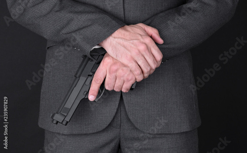 Man in suit with gun