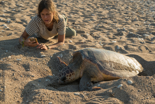 Girl near eggs laying turtle