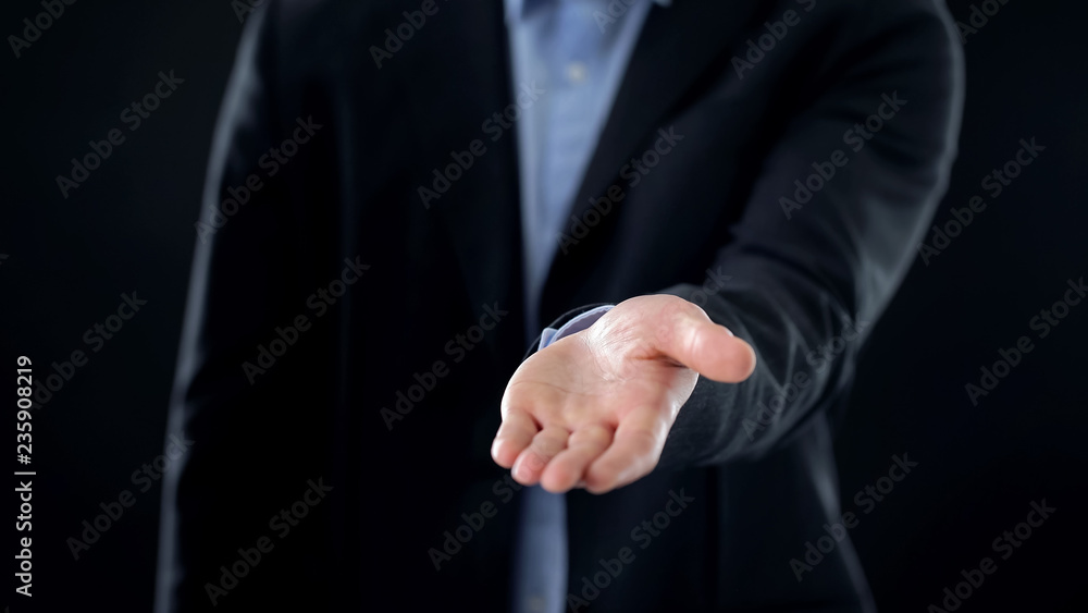 Businessman stretching open empty hand into camera, new offer investment