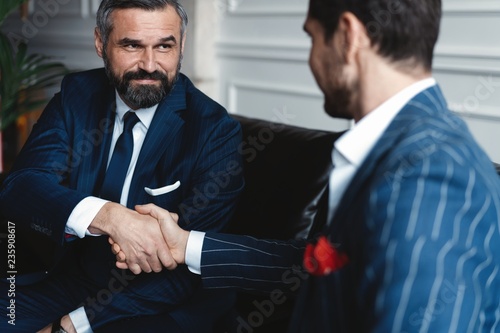 Business people shaking hands, finishing up a meeting.