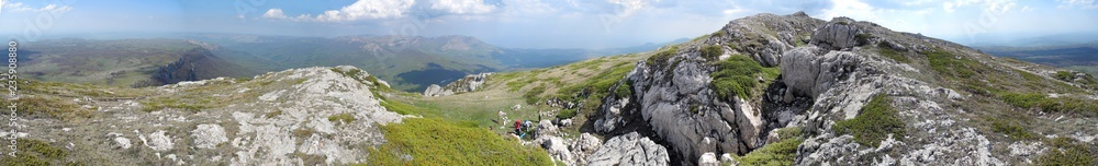 Panorama of rocky mountain ridge. Tourists made a halt. Crimean mountains.