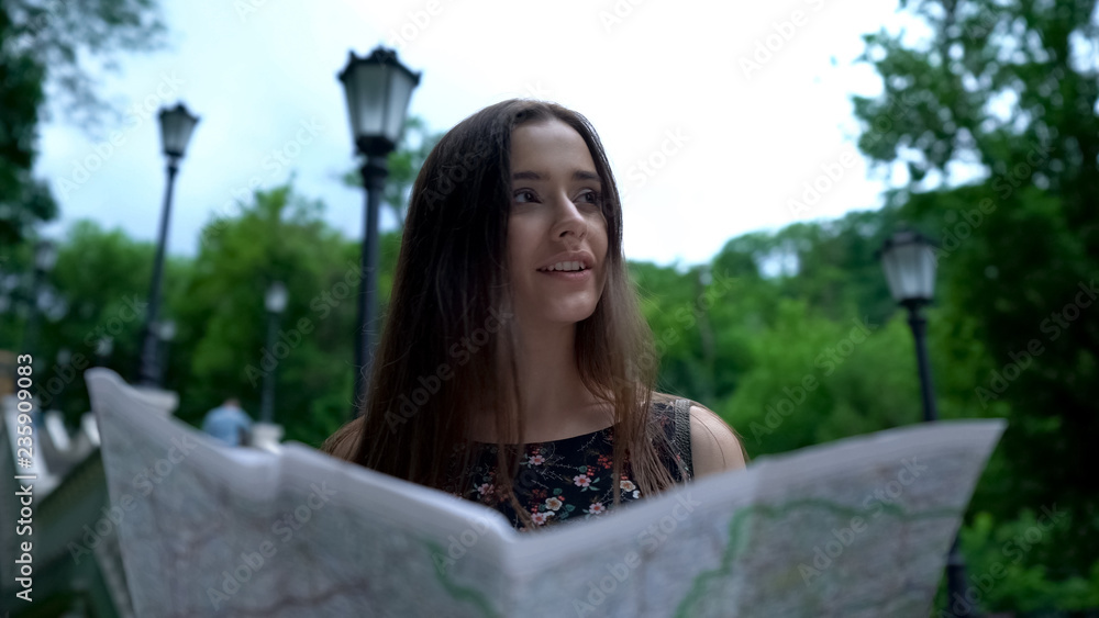 Girl tourist looking at map, successfully finds way to historical attraction Girl tourist looking at map, successfully finds way to historical attraction