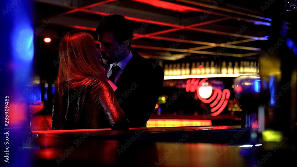 Young business man kissing woman in night club, couple of lovers, temptation Young business man kissing woman in night club, couple of lovers, temptation