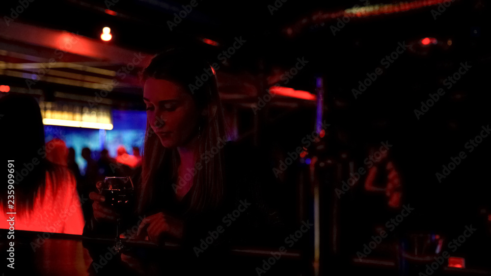 Upset lonely lady drinking wine at bar counter in night club, life problems Upset lonely lady drinking wine at bar counter in night club, life problems